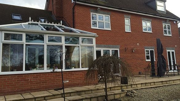 Worthing conservatory with white uPVC frames and a sloping glazed roof